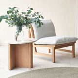 Pivot side table travertine top with oak base, cantaloupe fabric armchair - Originals Furniture Singapore