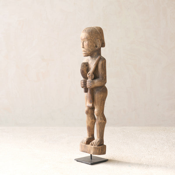 Vintage Naga Tribal Wood Sculpture handcrafted from solid hardwood in Nagaland, India and displayed on a steel stand.