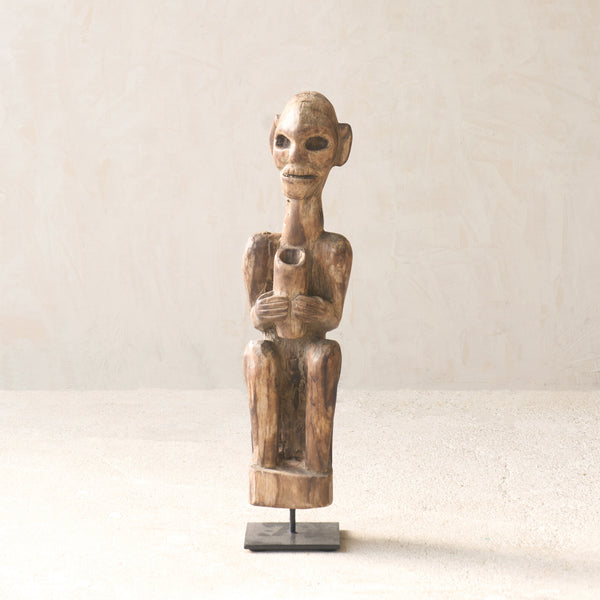Vintage Naga Tribal Wood Sculpture handcrafted from solid hardwood in Nagaland, India and displayed on a steel stand.