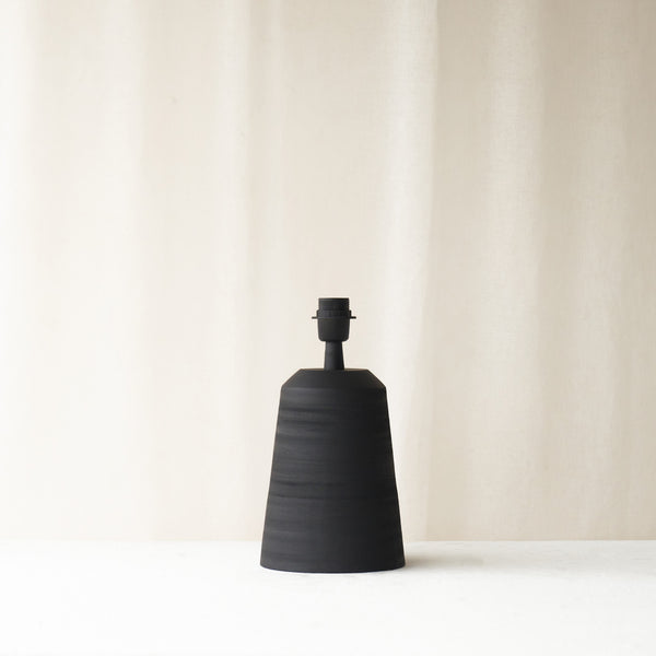 Lilou Table Lamp, black and sleek shaped. Sophisticated and stylish piece. It is a versatile piece that provides a touch of luxury and texture in any home. Available at $280.