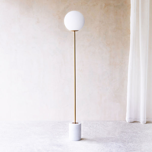 Medina Floor Lamp, marble base and glass shade. Bold and timeless statement piece. It is a functional piece that provides a touch of luxury in any home. Available at $680.