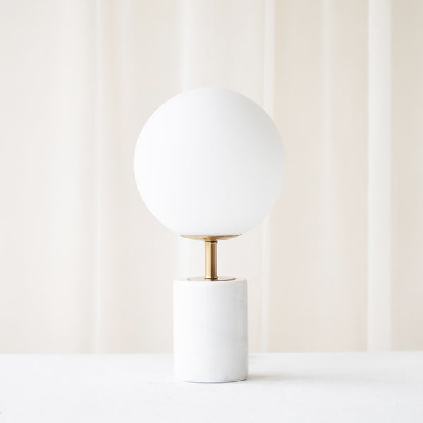 Medina Table Lamp, marble base and glass shade. Bold and timeless statement piece. It is a functional piece that provides a touch of luxury in any home. Available at $380.